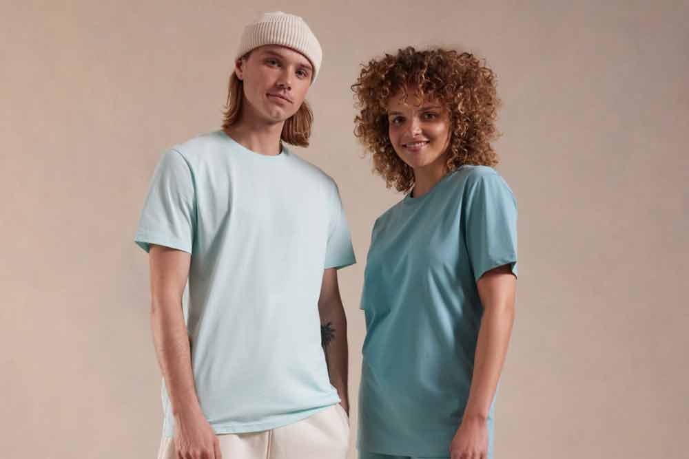 Man and woman wearing t-shirts for custom printing, showcasing style and versatility.