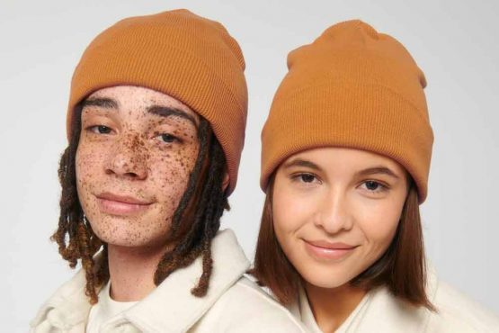 Man and woman wearing beanie hats for custom printing, showcasing style and warmth.