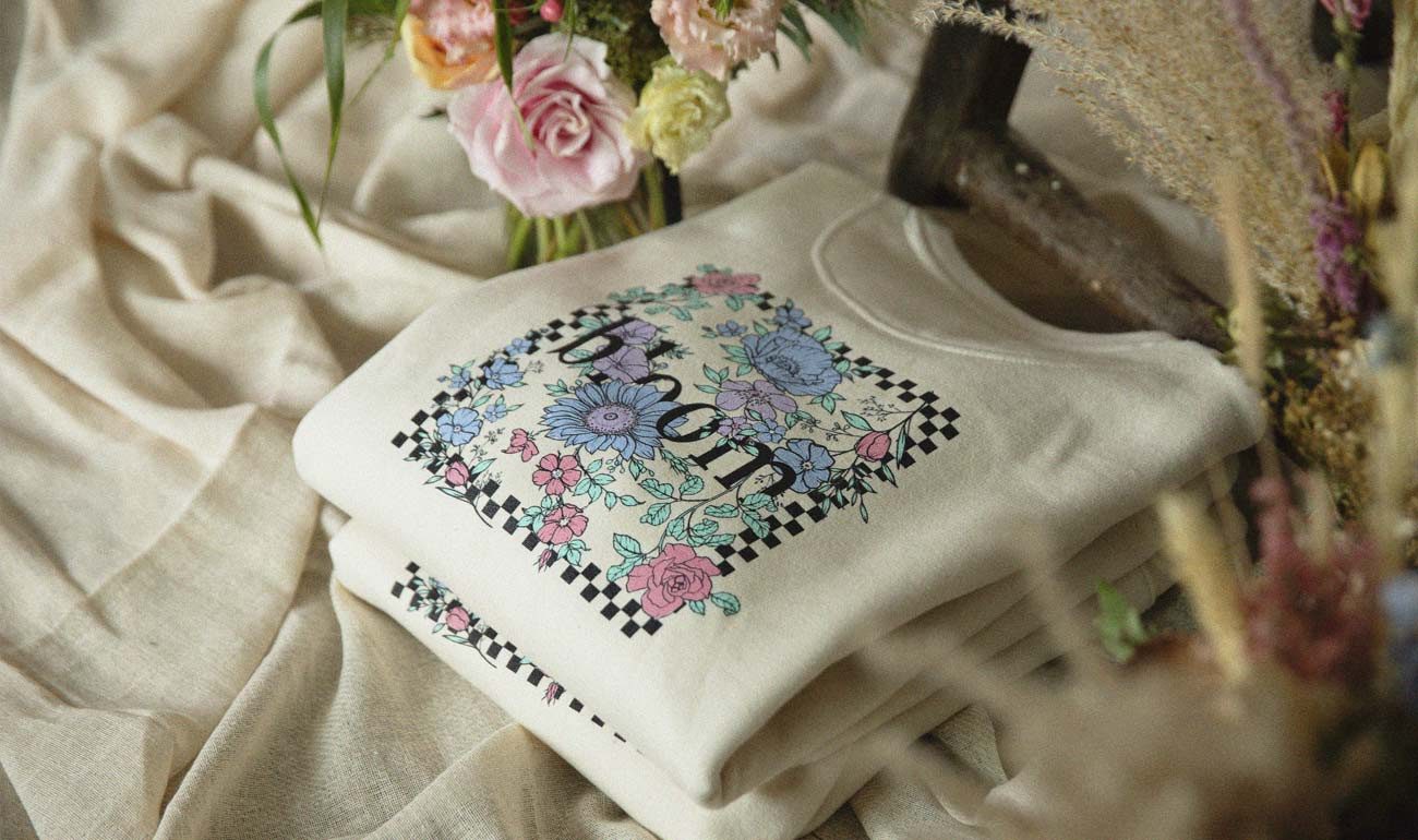 Stack of custom-printed t-shirts featuring photographic DTG designs